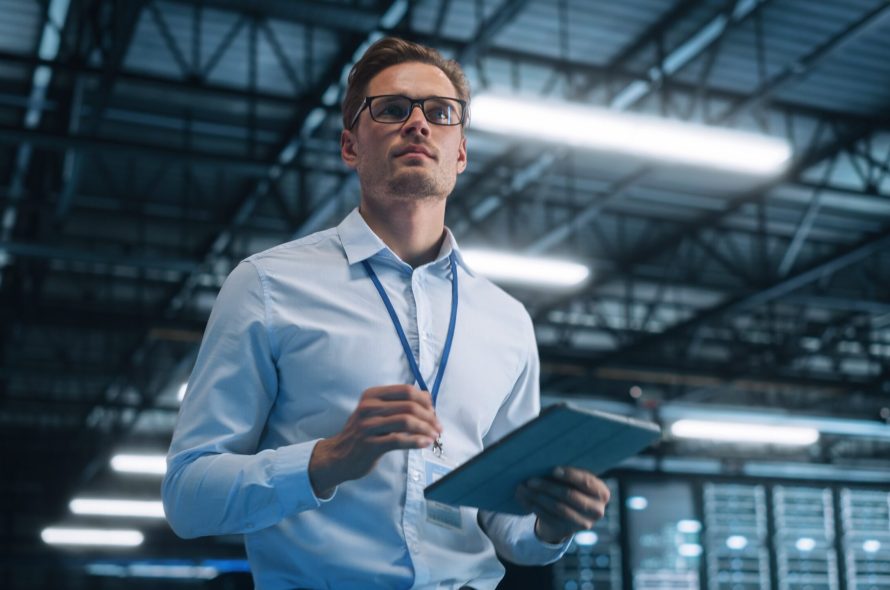 Portrait,Of,It,Specialist,Using,Tablet,Computer,In,Data,Center.